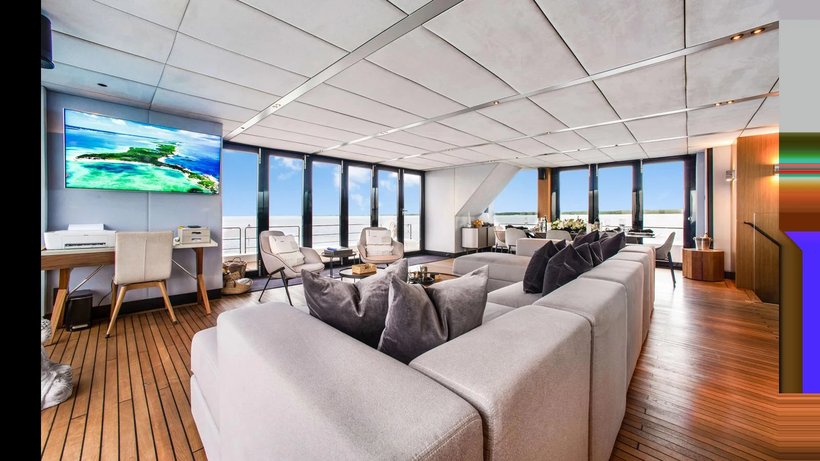 The spacious salon features modern furnishings and expansive windows offering stunning ocean views. aboard MIDORI Yacht for Sale