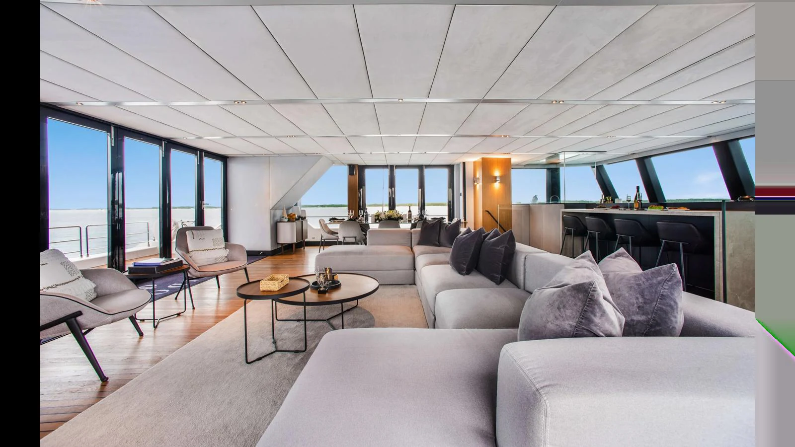 The spacious salon features modern furnishings and expansive windows offering panoramic views. aboard MIDORI Yacht for Sale
