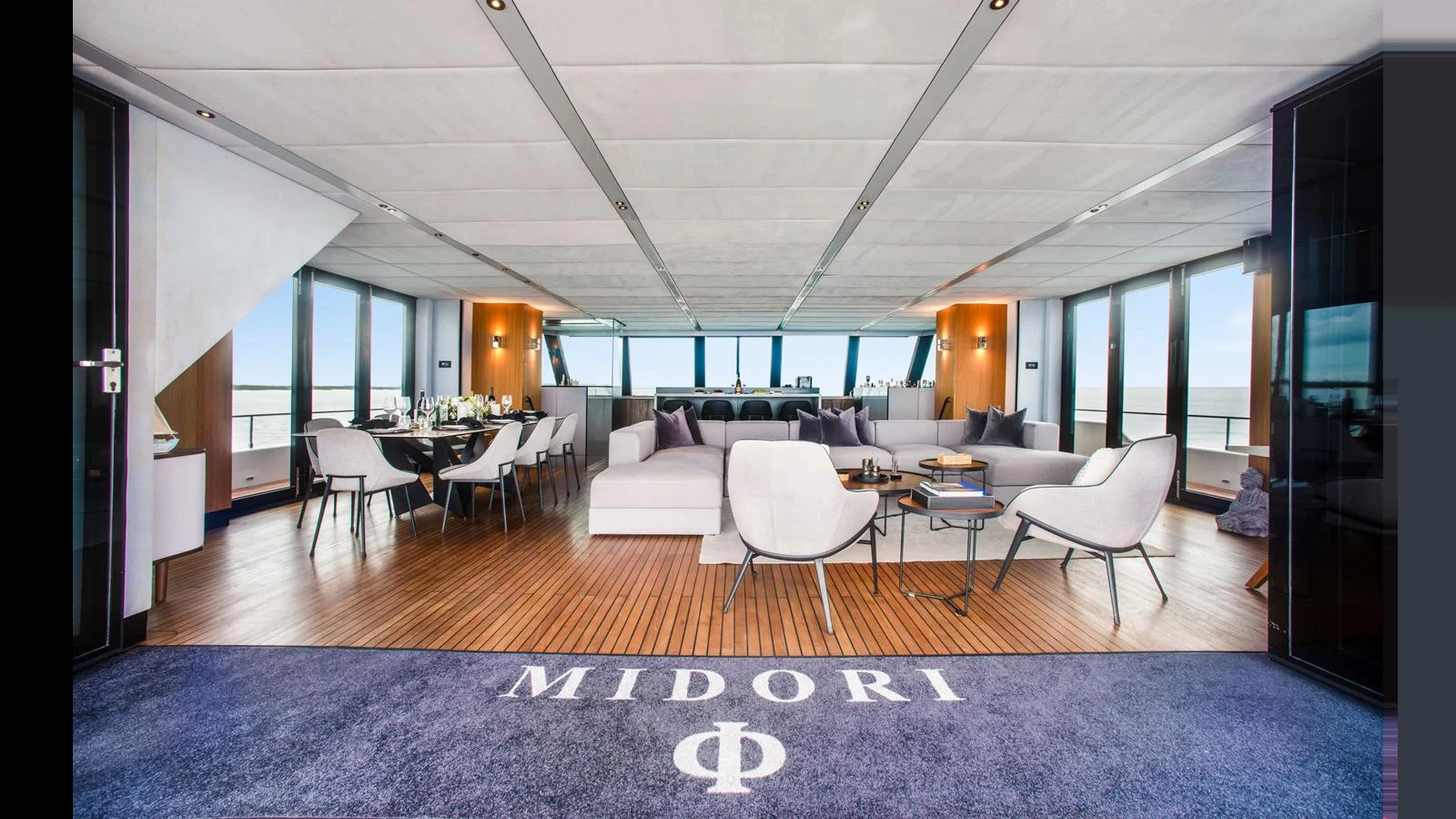 The yacht's salon features a spacious and elegantly designed seating area with panoramic windows. aboard MIDORI Yacht for Sale