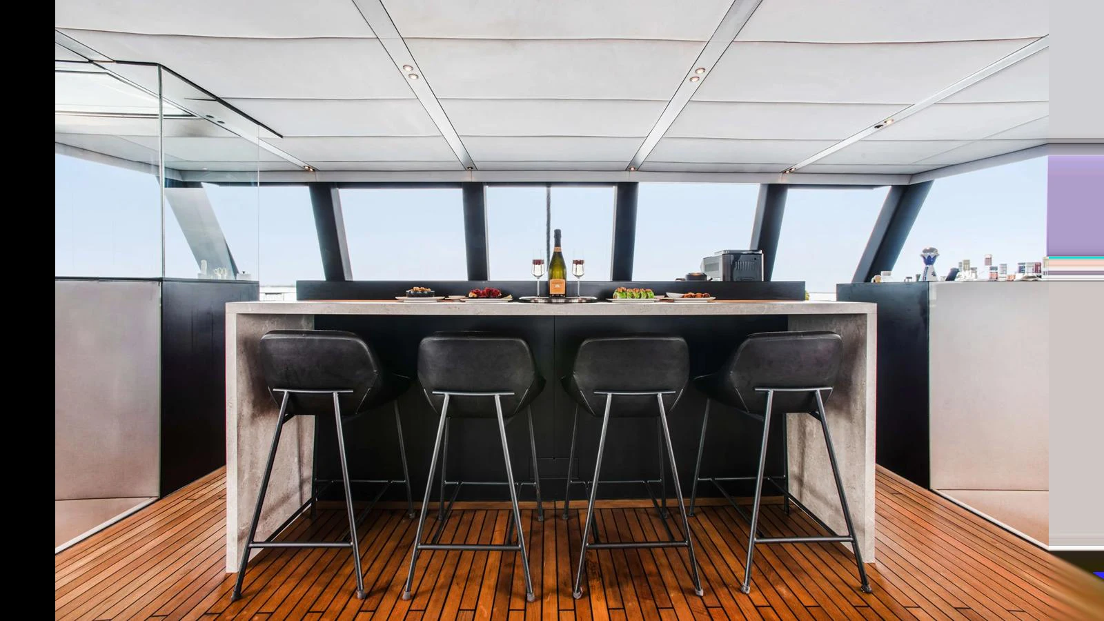 A sleek and modern bar area with a panoramic view, perfect for entertaining guests. aboard MIDORI Yacht for Sale