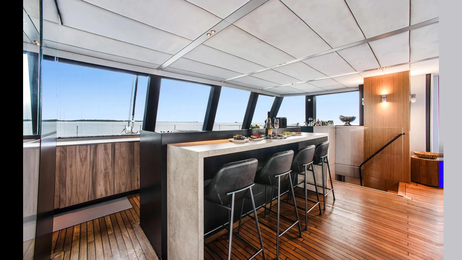 A modern galley with a sleek bar area and panoramic windows. aboard MIDORI Yacht for Sale