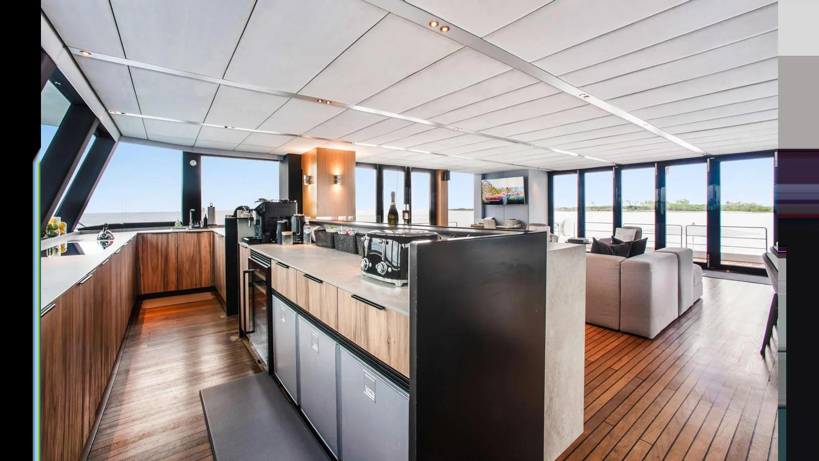 The yacht's galley features modern appliances and a spacious layout, seamlessly integrated with the open-plan living area. aboard MIDORI Yacht for Sale