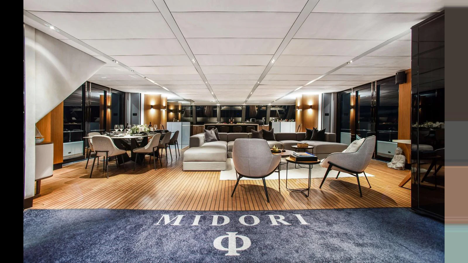 The spacious salon features elegant seating and a sophisticated dining area. aboard MIDORI Yacht for Sale