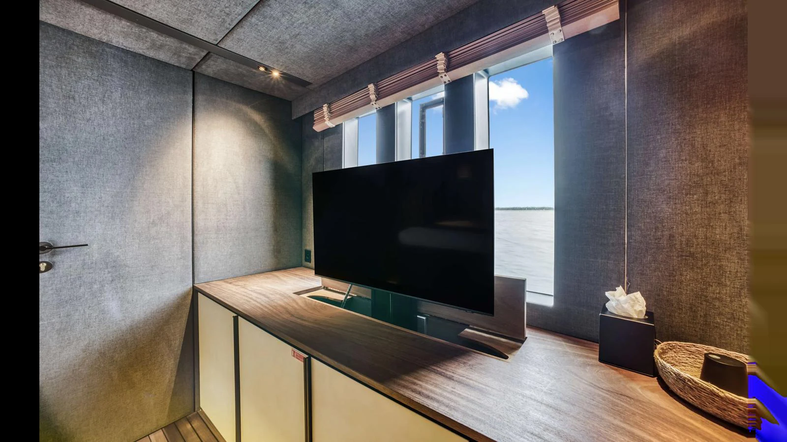 A cozy interior space featuring a large flat-screen TV and modern decor. aboard MIDORI Yacht for Sale