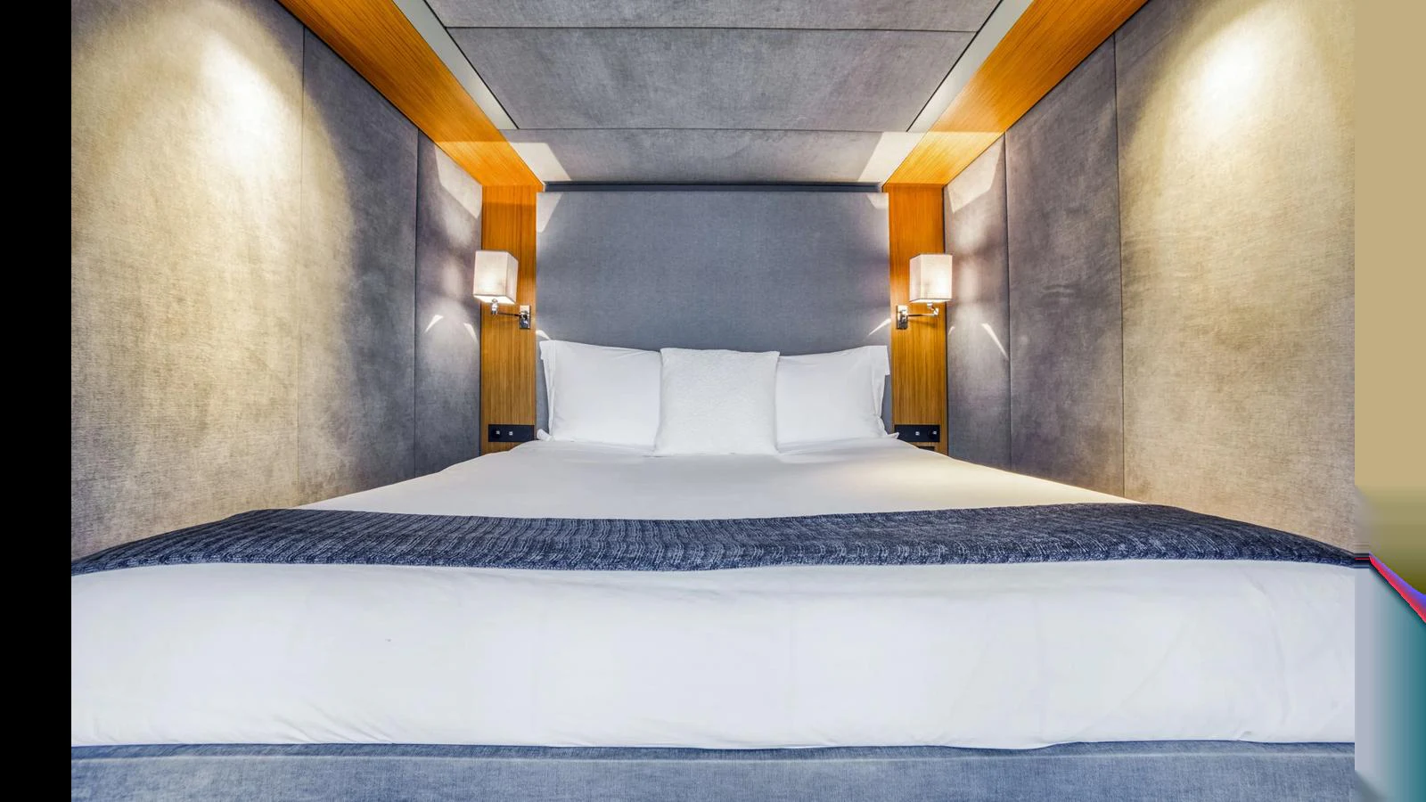 The stateroom features a luxurious bed with elegant lighting and modern decor. aboard MIDORI Yacht for Sale