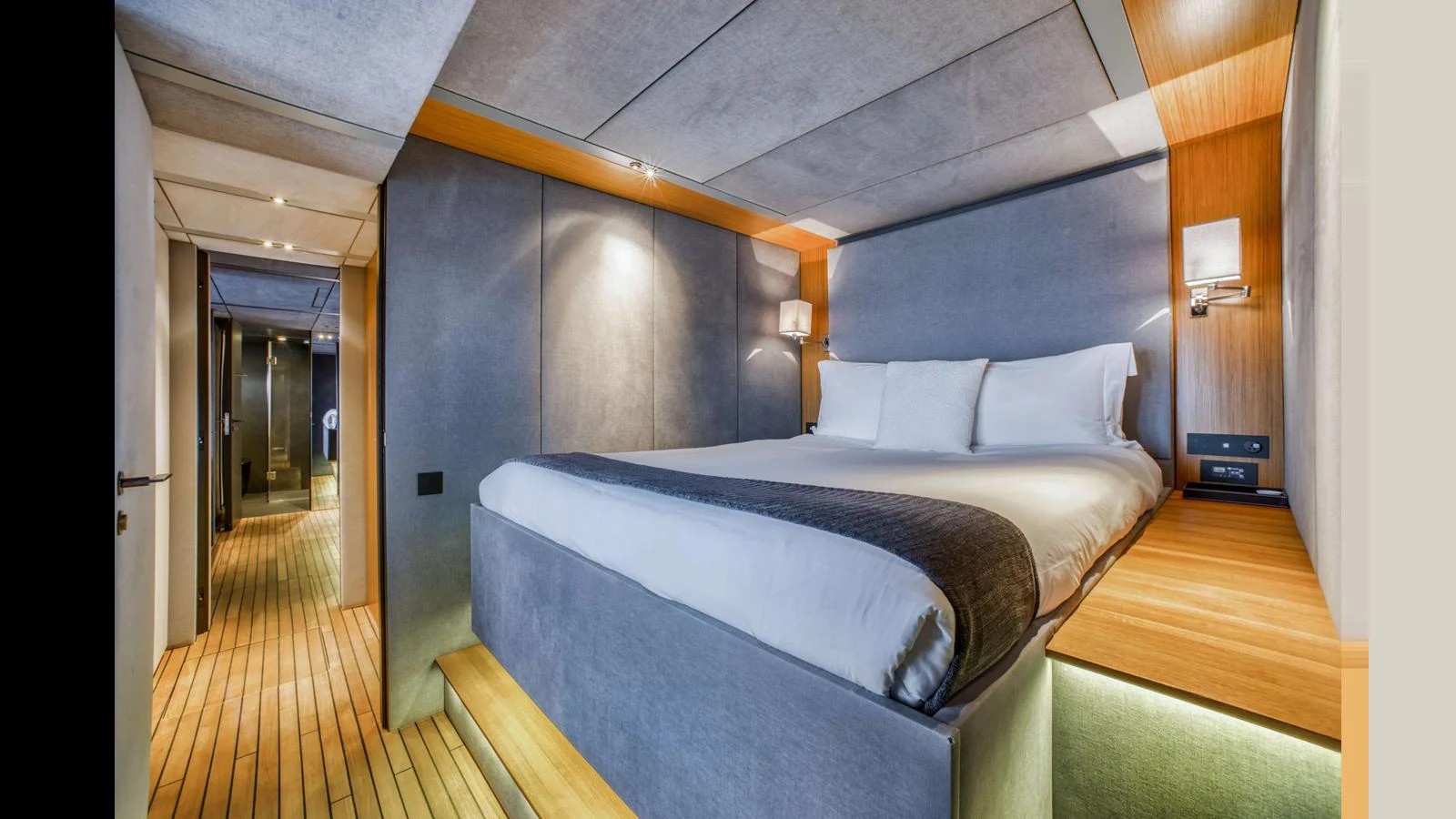 The master stateroom features a luxurious bed with modern lighting and sleek design elements. aboard MIDORI Yacht for Sale