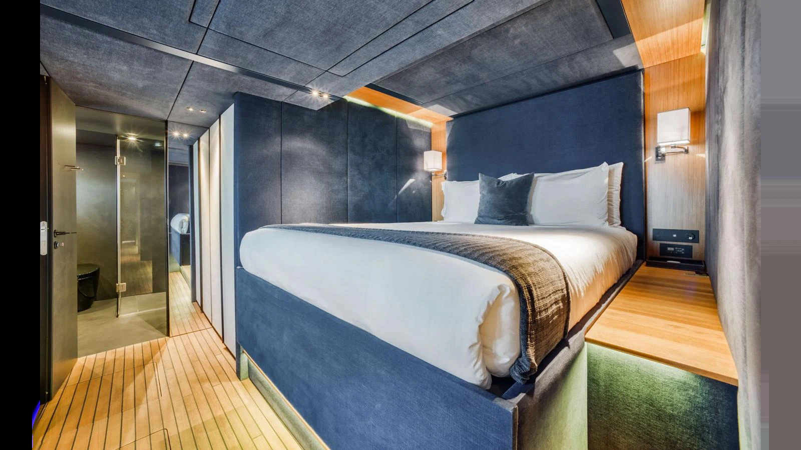 A luxurious stateroom featuring a plush bed with modern lighting and sleek design elements. aboard MIDORI Yacht for Sale