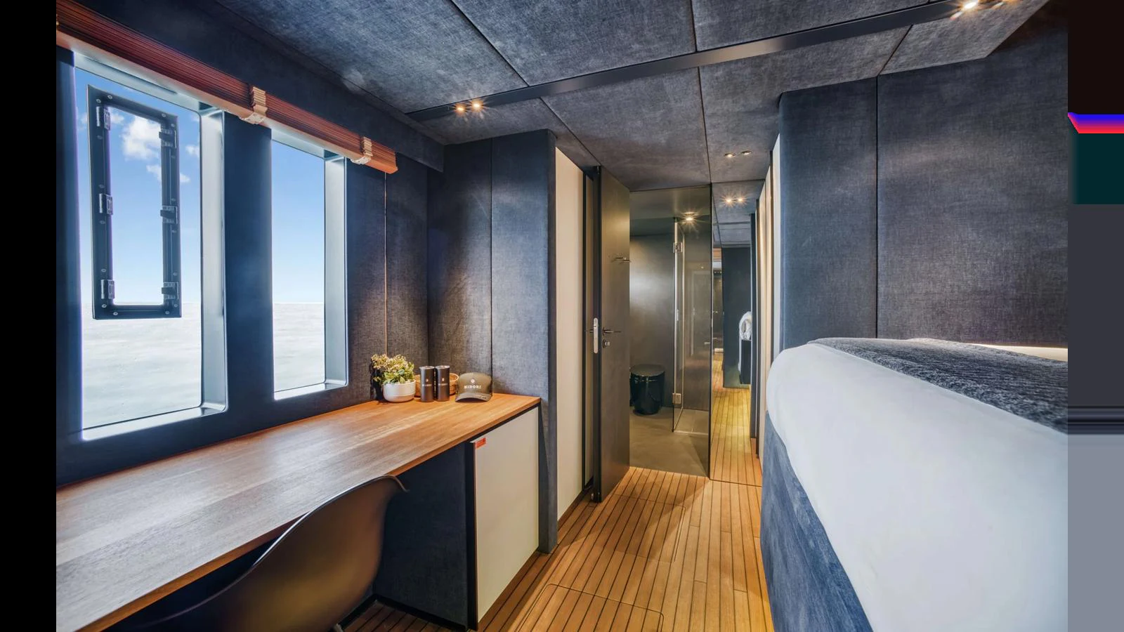 This image showcases a modern stateroom with sleek design and ample natural light. aboard MIDORI Yacht for Sale