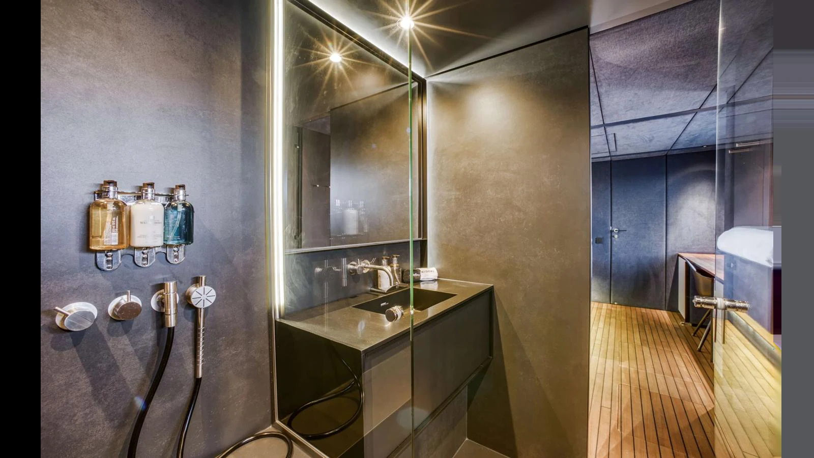 A modern yacht bathroom with sleek fixtures and ambient lighting. aboard MIDORI Yacht for Sale