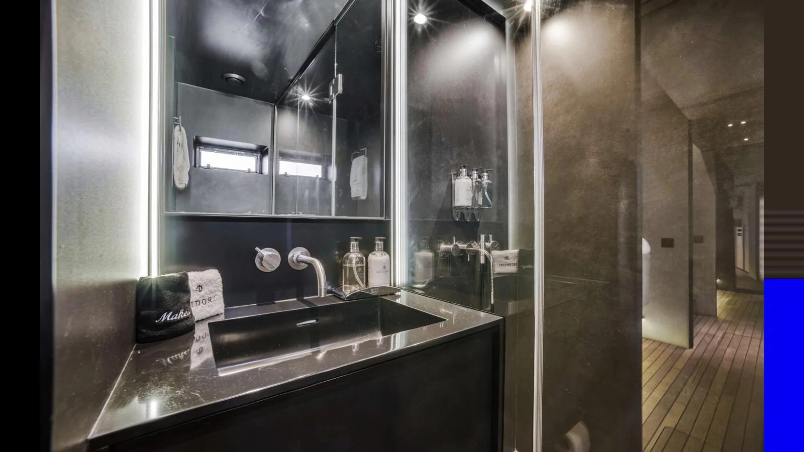 A sleek and modern bathroom with elegant fixtures and ambient lighting. aboard MIDORI Yacht for Sale