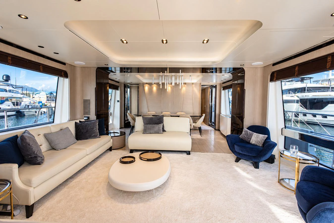 The salon features luxurious seating with elegant decor and ample natural light from large windows. aboard ESCAPE Yacht for Sale