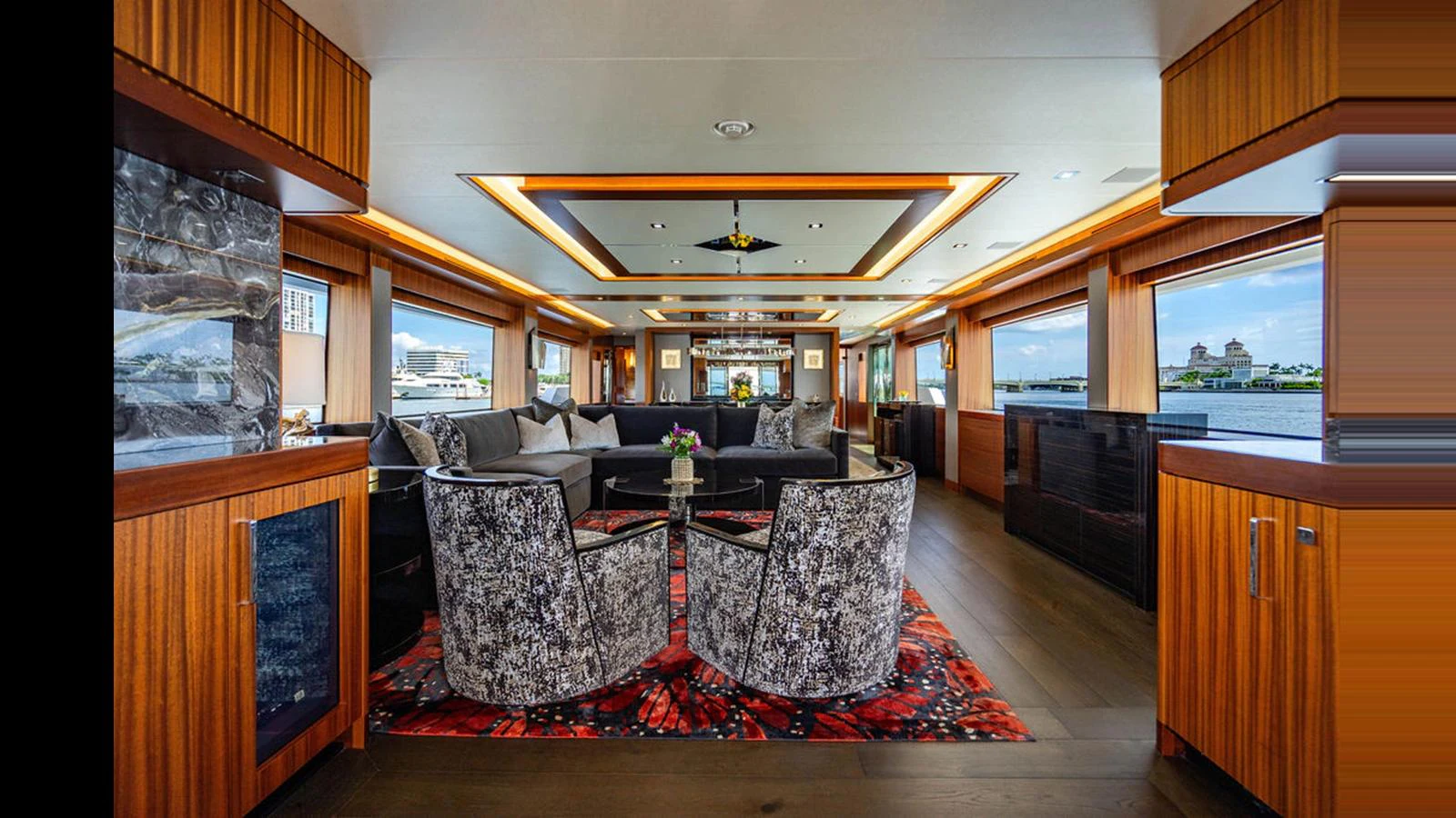 The salon features elegant seating with a modern design and panoramic windows offering stunning views. aboard TRU LUV Yacht for Sale