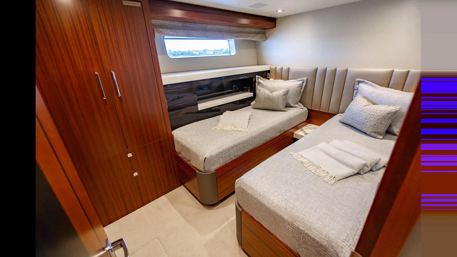 The guest stateroom features twin beds with elegant bedding and rich wood finishes. aboard TRU LUV Yacht for Sale