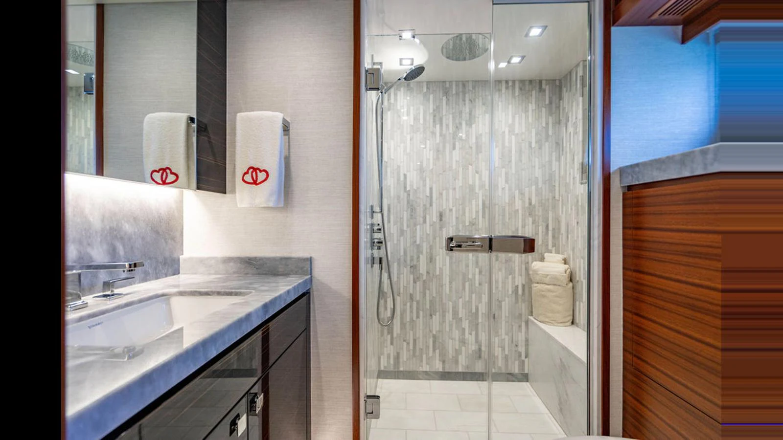 The yacht's bathroom features a modern design with a spacious shower and elegant fixtures. aboard TRU LUV Yacht for Sale