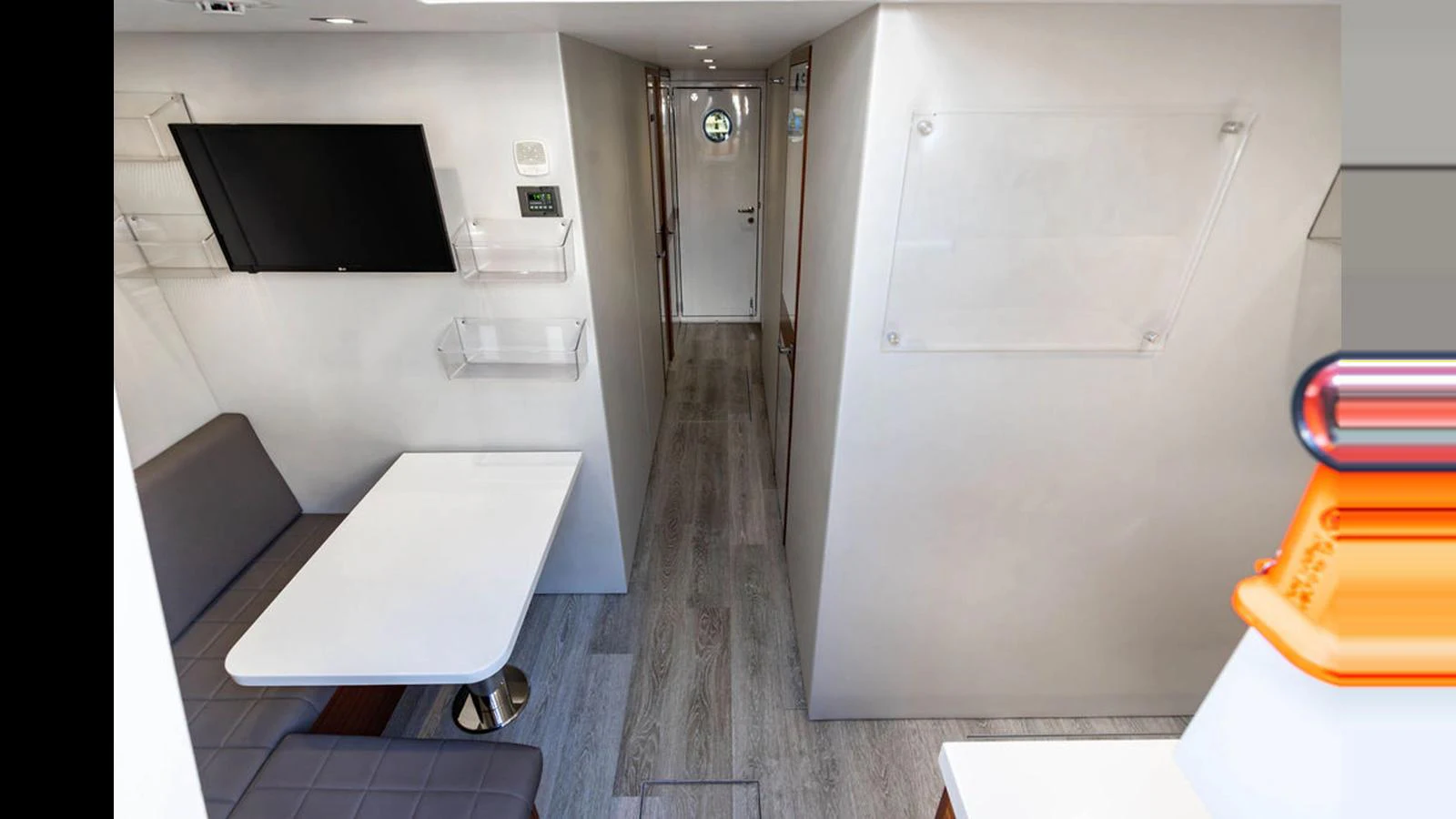 A modern yacht interior featuring a compact dining area and sleek design elements. aboard TRU LUV Yacht for Sale