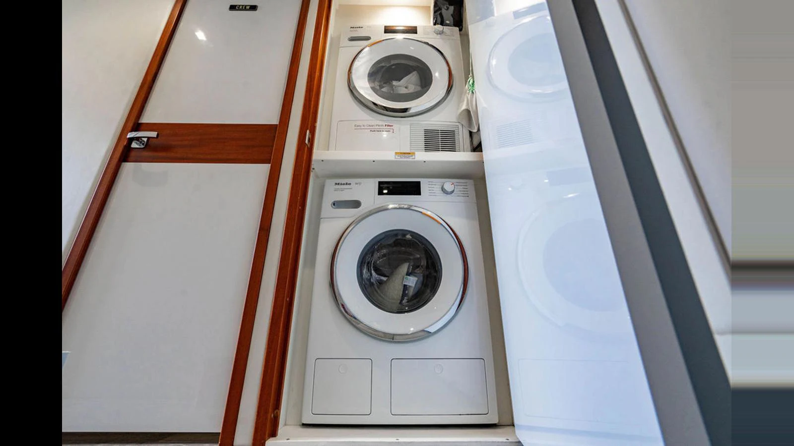 The yacht features a well-equipped laundry room with modern appliances. aboard TRU LUV Yacht for Sale