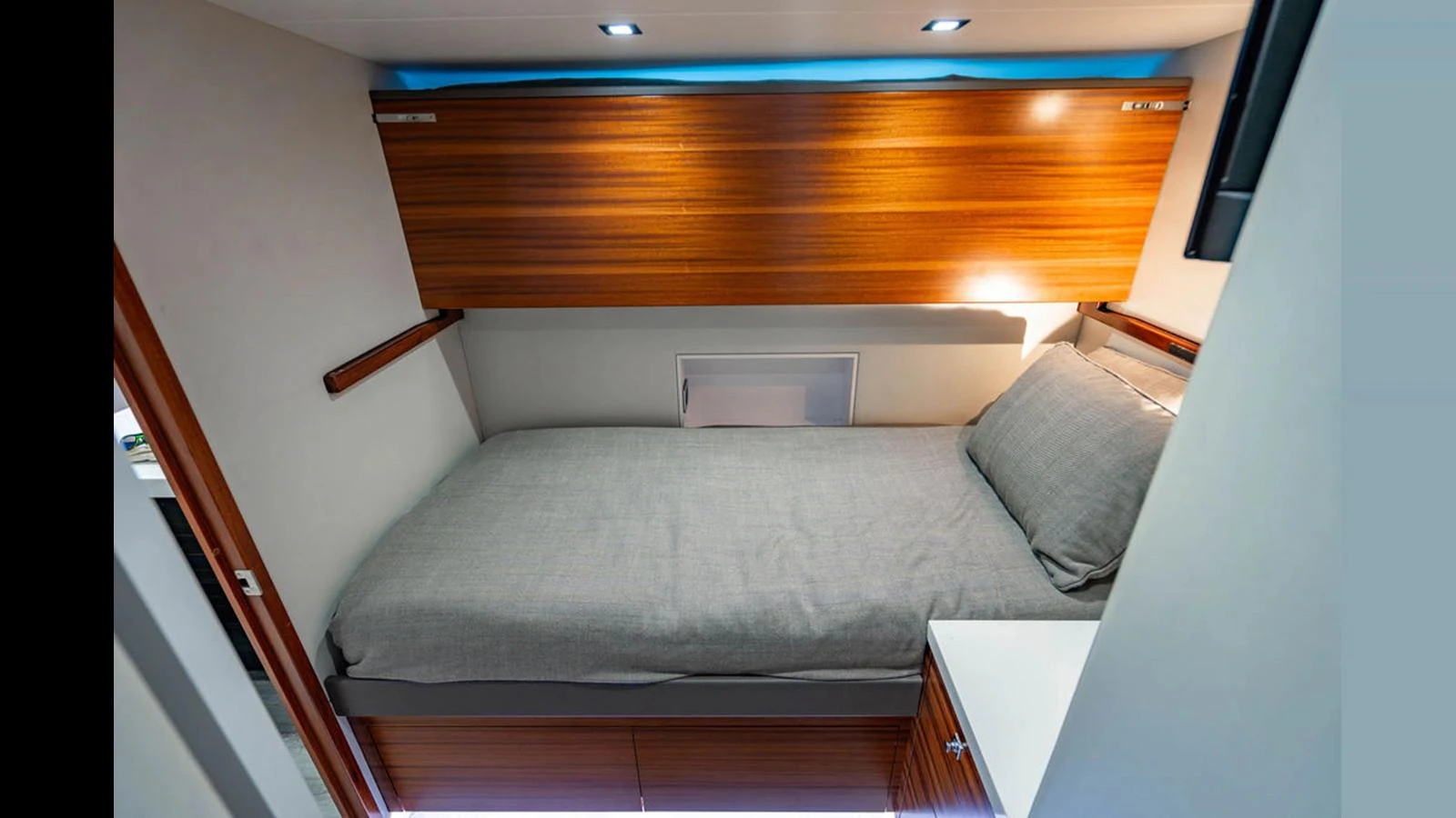 A cozy cabin with a single bed and modern wooden finishes. aboard TRU LUV Yacht for Sale
