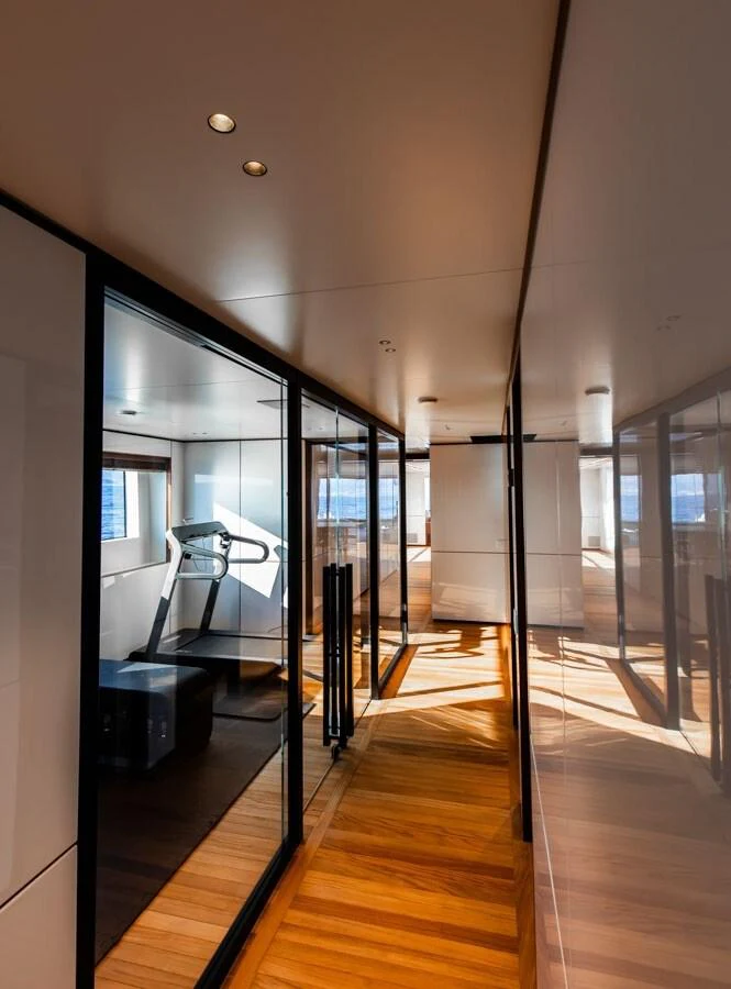 The yacht's interior gym features modern equipment and ample natural light. aboard CADA DIA Yacht for Sale