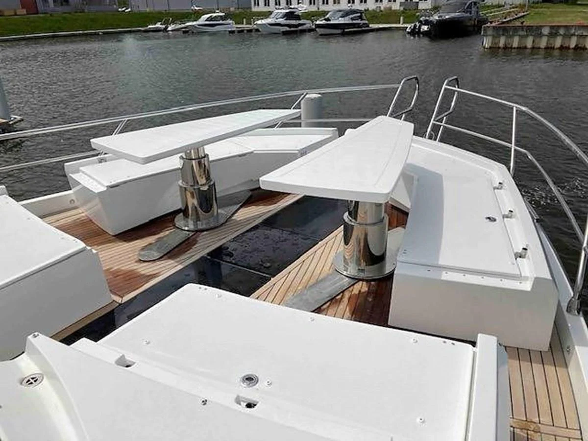 The bow area features sleek seating arrangements and polished metal fixtures. aboard GLN Yacht for Sale