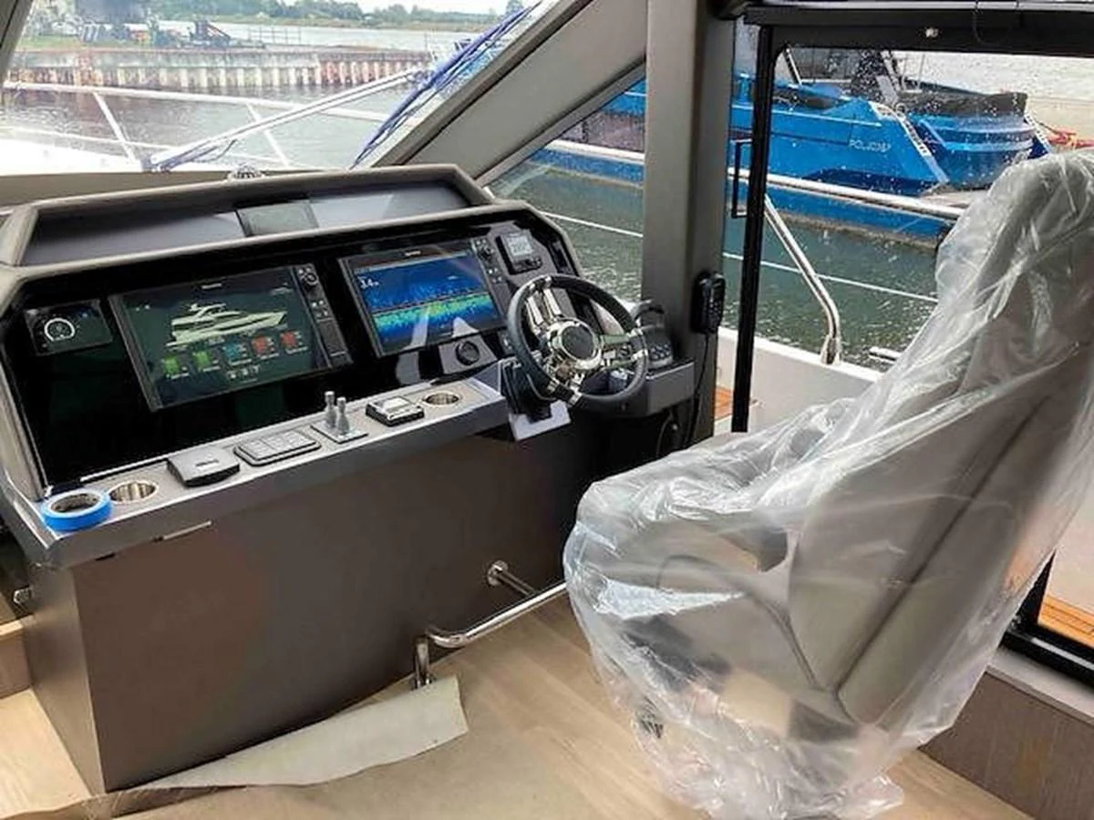 The helm station features advanced navigation equipment and a comfortable captain's chair. aboard GLN Yacht for Sale