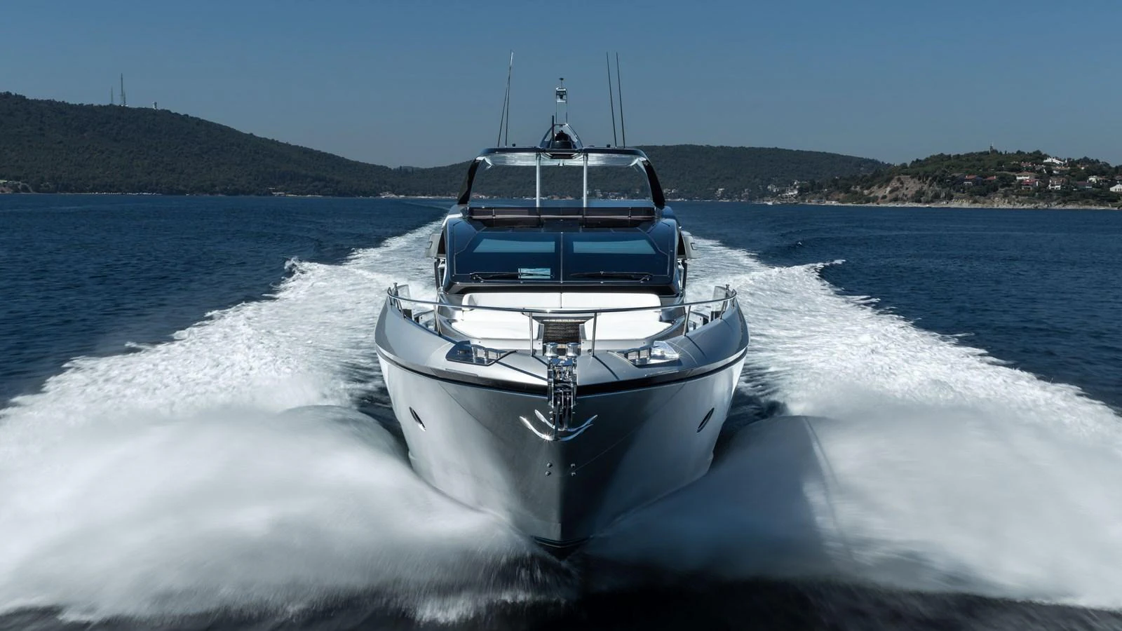 A sleek yacht cuts through the water, showcasing its powerful design and luxurious exterior. aboard CREA Yacht for Sale