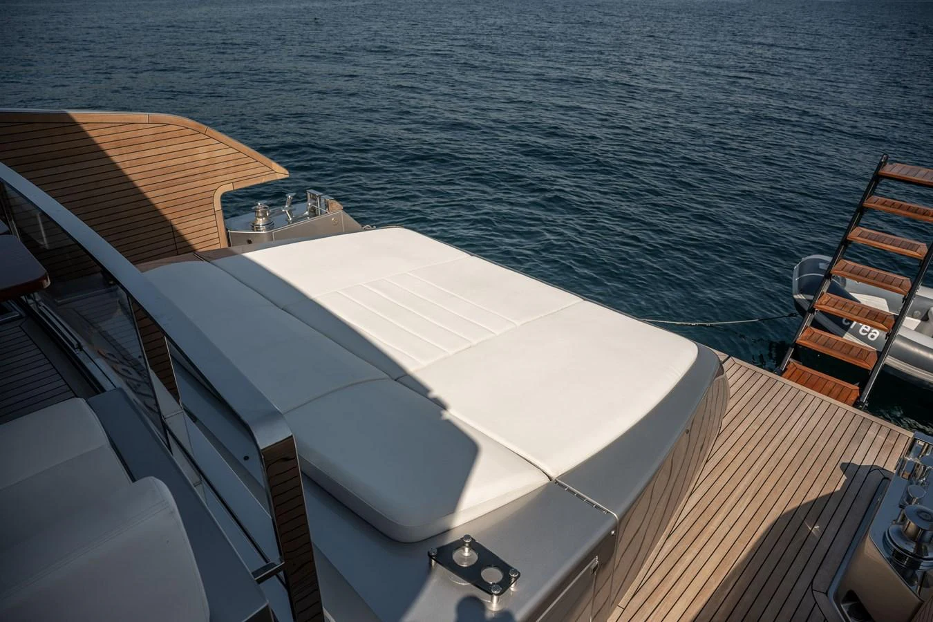 The sundeck offers a luxurious space for relaxation with a large sunbed overlooking the serene ocean. aboard CREA Yacht for Sale