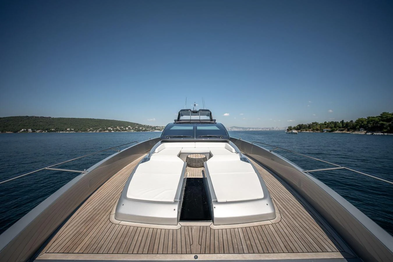 The yacht's foredeck features luxurious sun pads with a stunning view of the surrounding waters. aboard CREA Yacht for Sale
