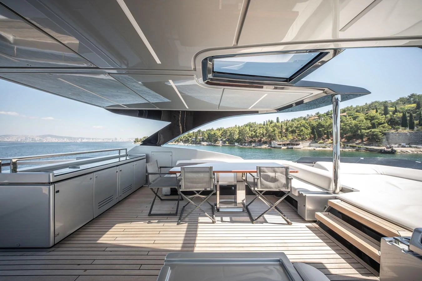 The aft deck offers a spacious and luxurious outdoor dining area with stunning views. aboard CREA Yacht for Sale