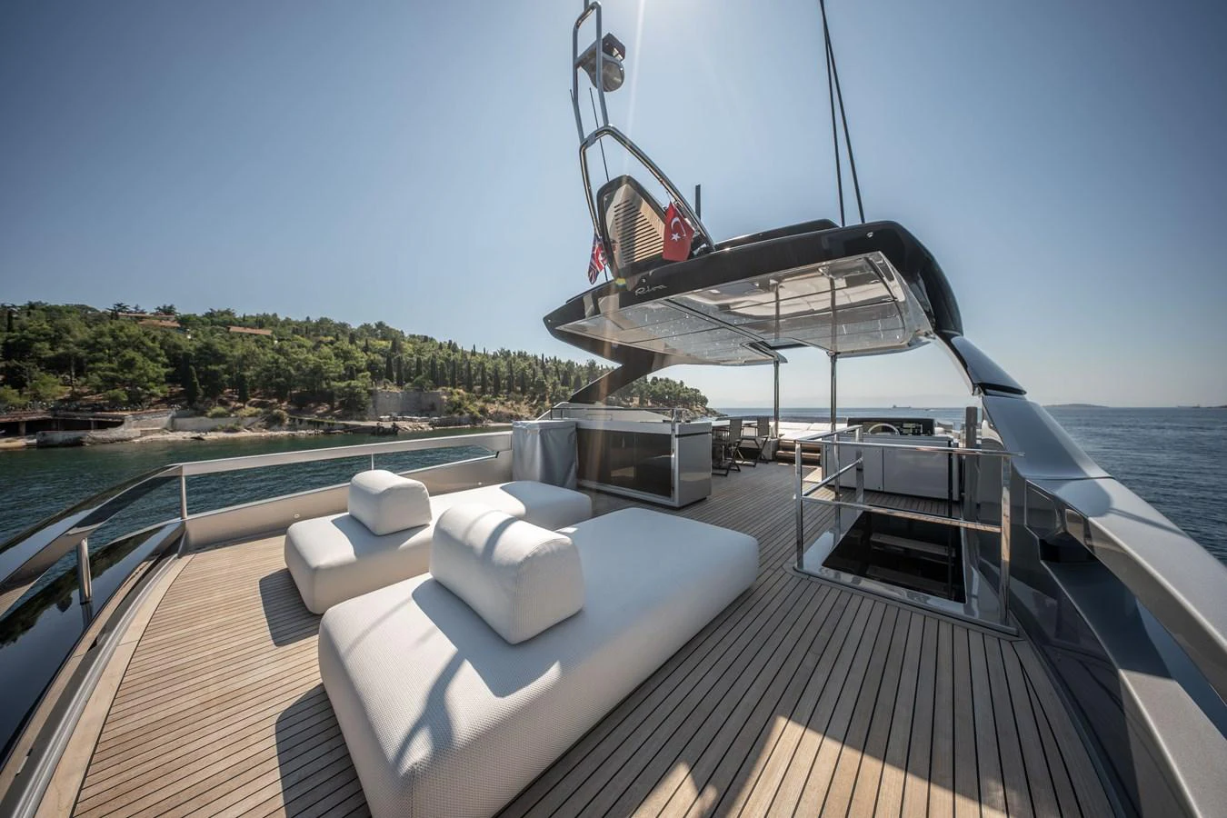The flybridge offers a spacious and luxurious outdoor lounging area with ample seating and stunning views. aboard CREA Yacht for Sale