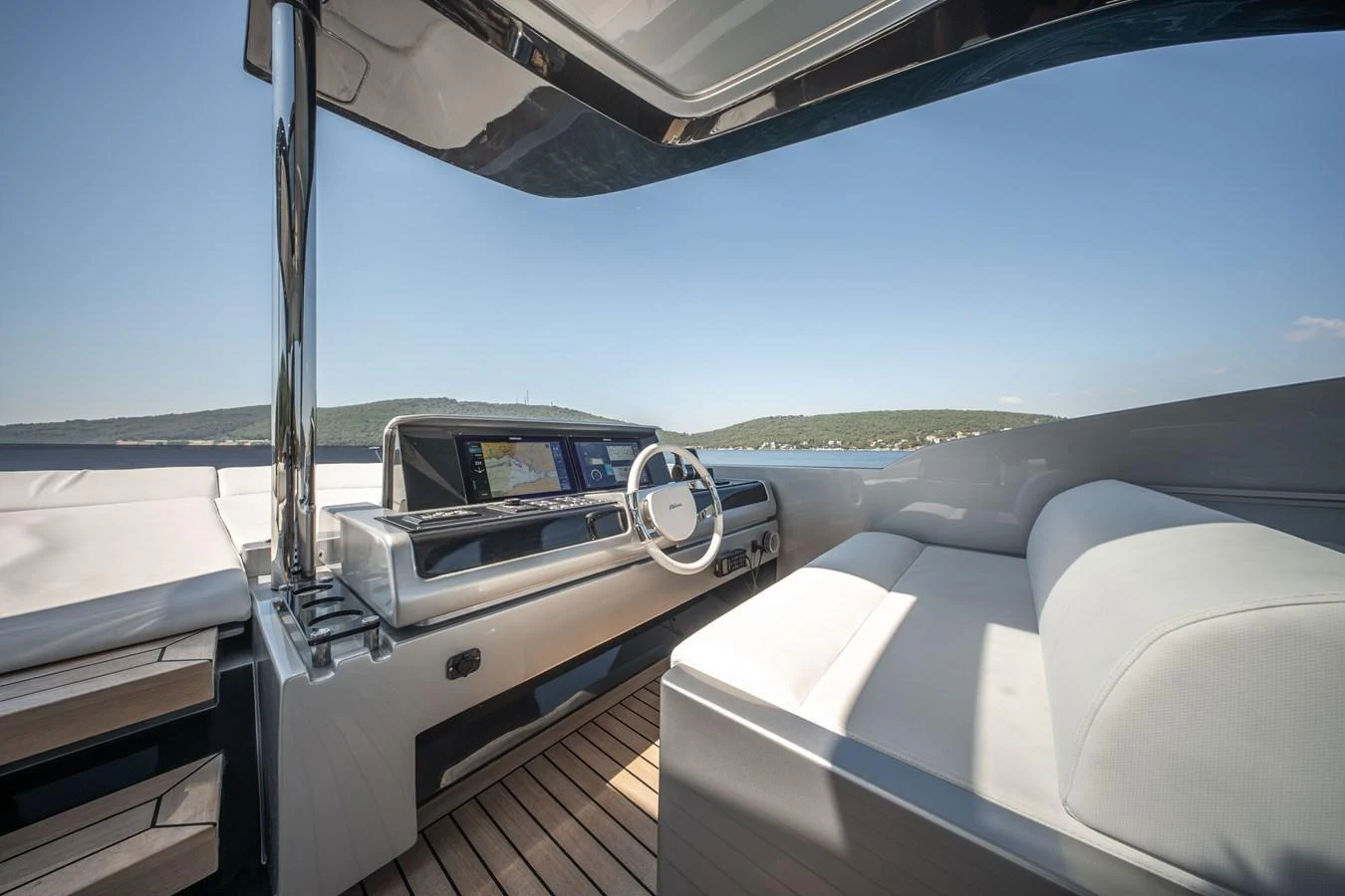 The helm area features a sleek, modern design with a comfortable seating arrangement and advanced navigation equipment. aboard CREA Yacht for Sale
