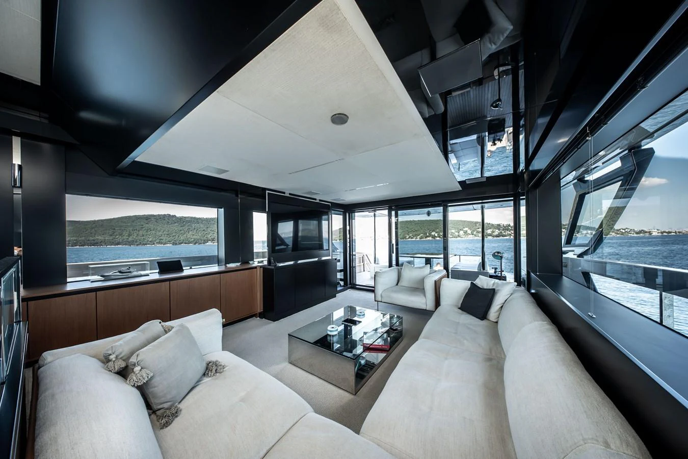 The salon offers a spacious and modern living area with panoramic views of the water. aboard CREA Yacht for Sale