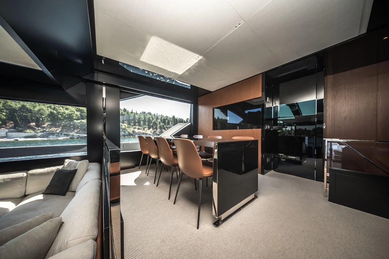 The salon features elegant furnishings with panoramic windows offering stunning views. aboard CREA Yacht for Sale