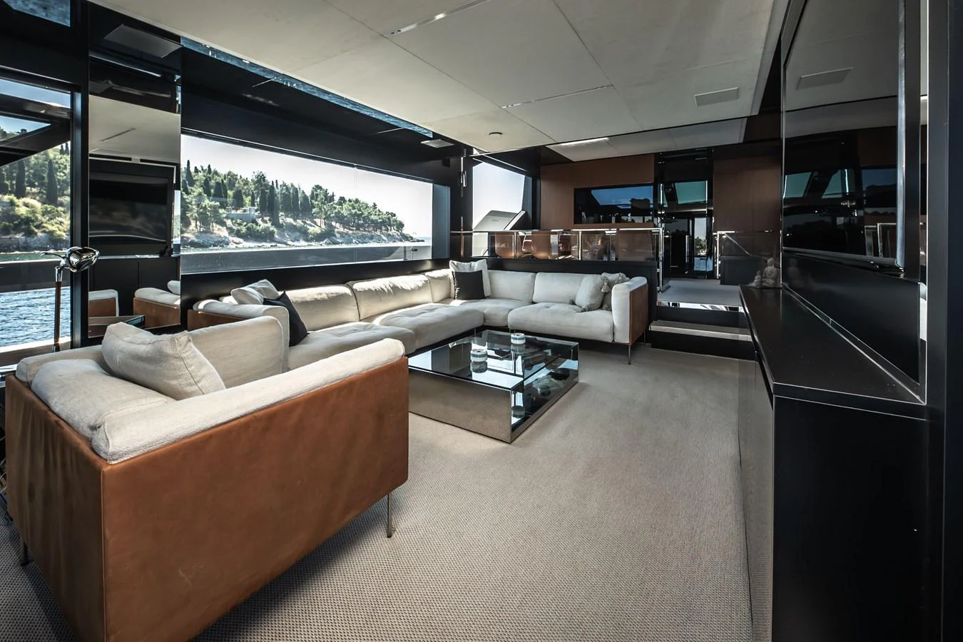 The salon features luxurious seating with panoramic views of the surrounding waters. aboard CREA Yacht for Sale