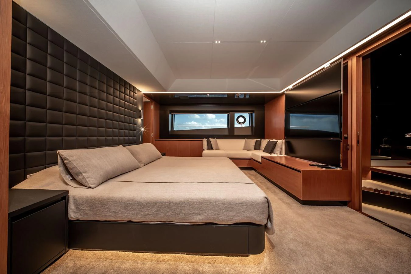 The master stateroom features a luxurious bed, modern decor, and ample natural light. aboard CREA Yacht for Sale