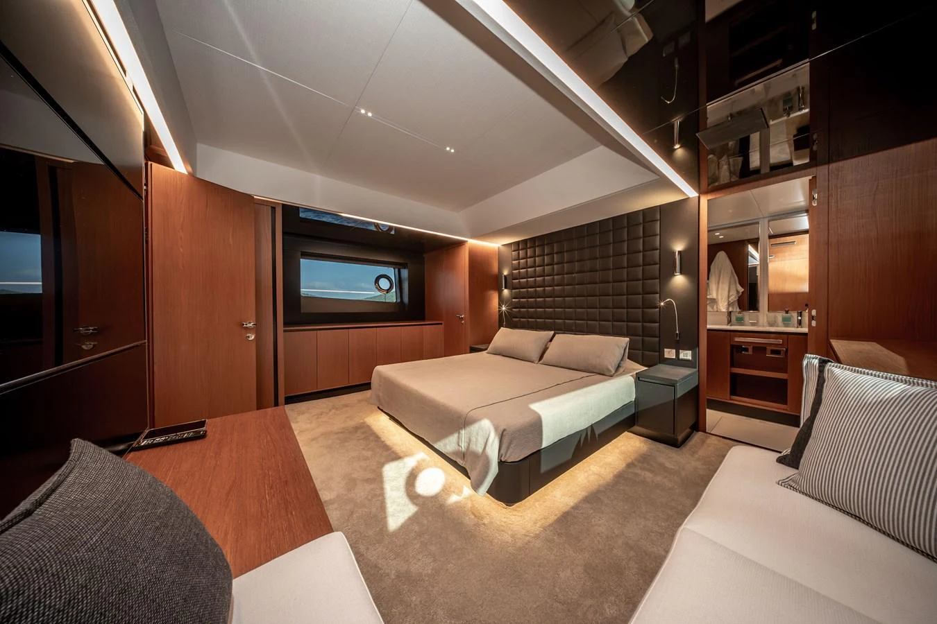 The master stateroom features a luxurious bed with elegant lighting and modern decor. aboard CREA Yacht for Sale