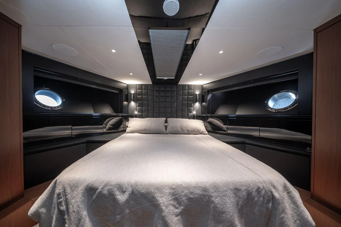 The master stateroom features a luxurious bed with modern design elements and ample lighting. aboard CREA Yacht for Sale