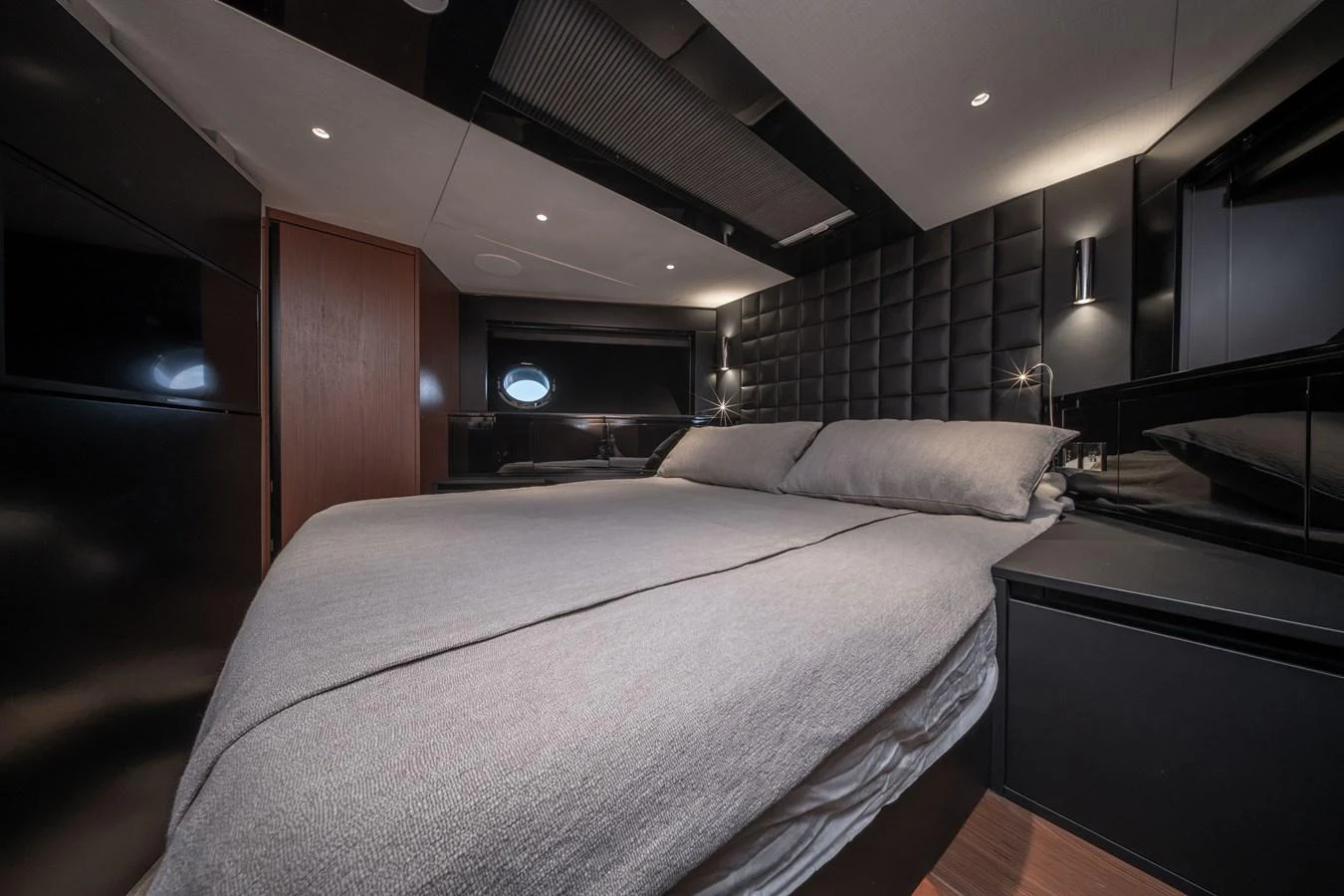 The stateroom exudes modern elegance with its sleek design and luxurious bedding. aboard CREA Yacht for Sale