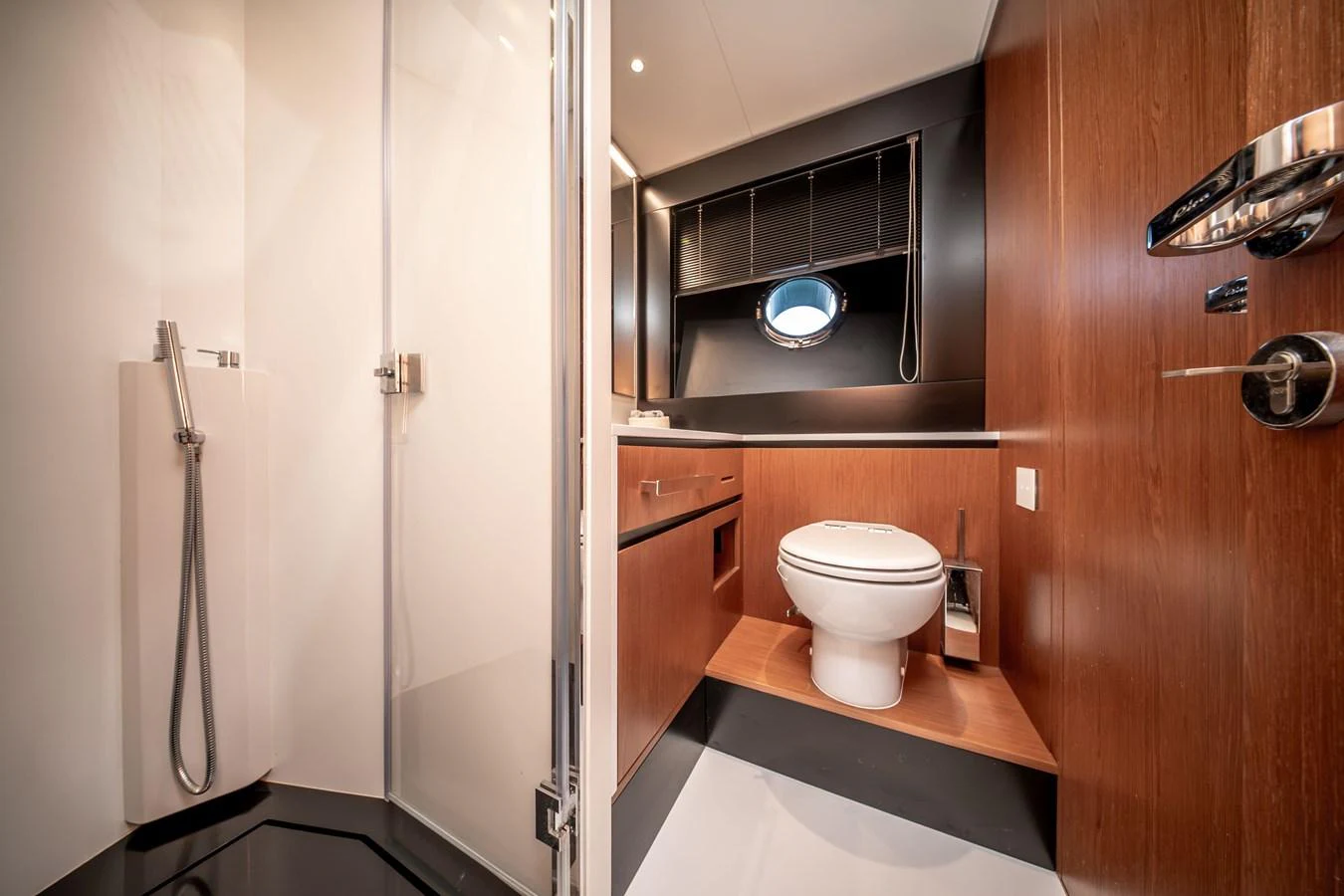 The yacht's bathroom features modern fixtures and a sleek design with wood accents. aboard CREA Yacht for Sale