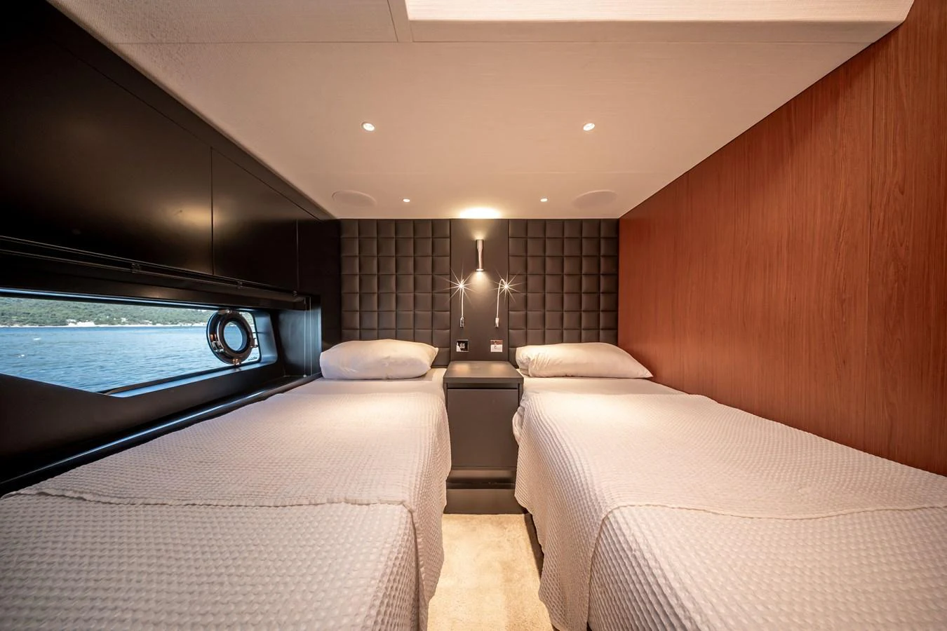 The twin stateroom features two comfortable beds with a modern and elegant design. aboard CREA Yacht for Sale