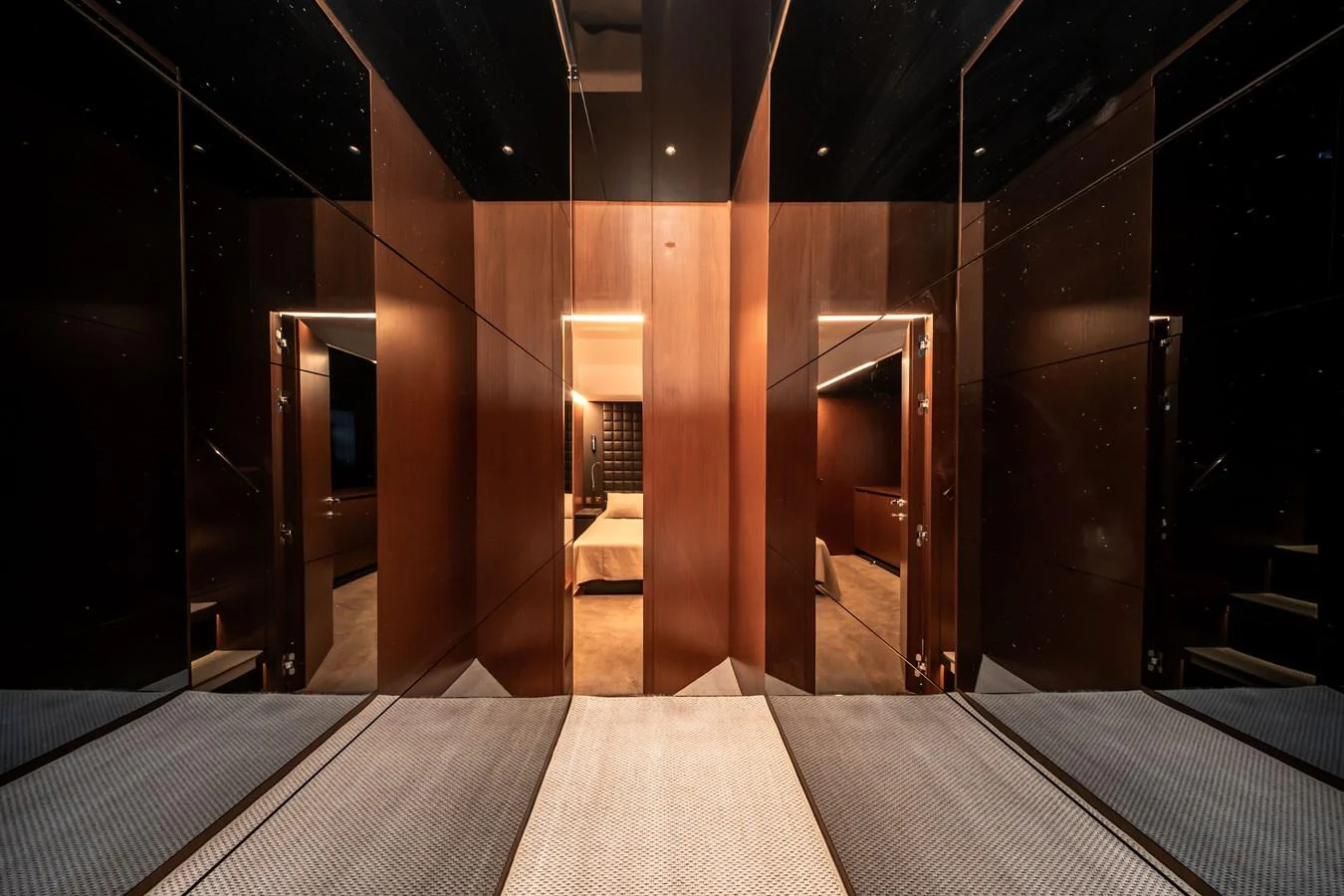 The yacht's interior features a modern, sleek design with warm wood paneling and ambient lighting. aboard CREA Yacht for Sale