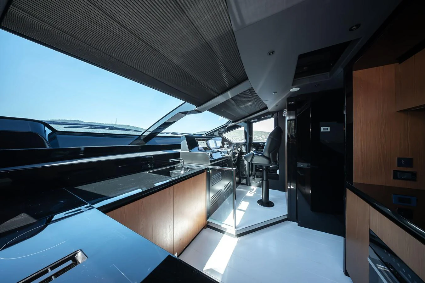The sleek and modern helm station offers panoramic views and state-of-the-art navigation equipment. aboard CREA Yacht for Sale