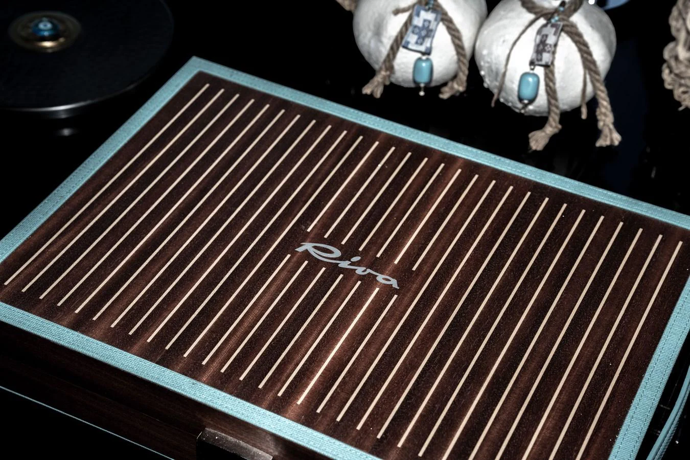 A close-up view of a finely crafted wooden panel with the yacht's logo. aboard CREA Yacht for Sale