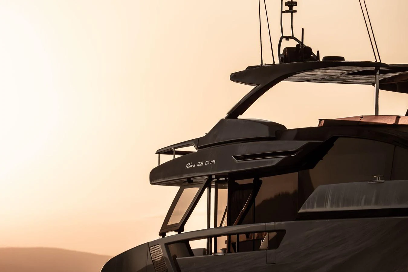A sleek yacht exterior is silhouetted against a warm, golden sky. aboard CREA Yacht for Sale