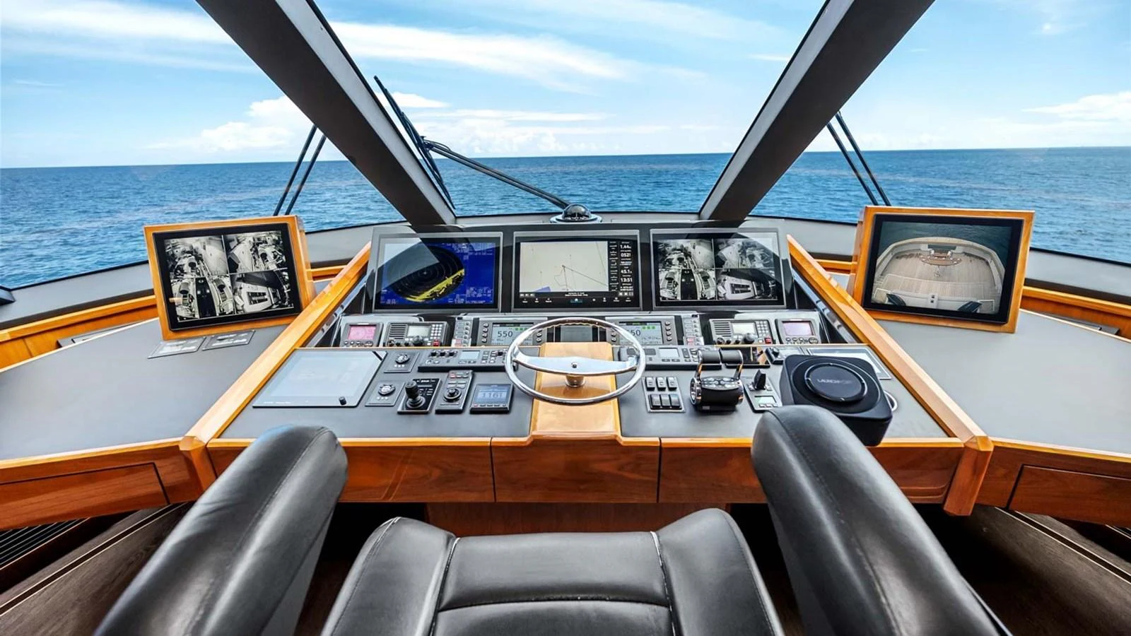The helm station offers a commanding view with advanced navigation equipment and luxurious seating. aboard DOUBLE BARREL Yacht for Sale
