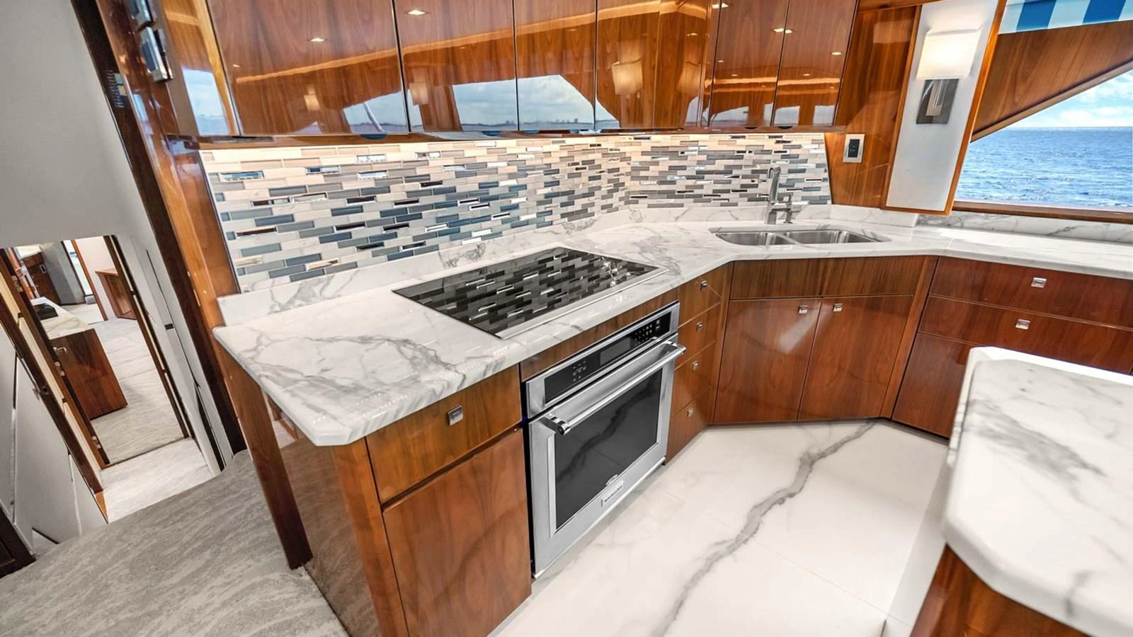 The galley features sleek wooden cabinetry, modern appliances, and a stylish backsplash. aboard DOUBLE BARREL Yacht for Sale