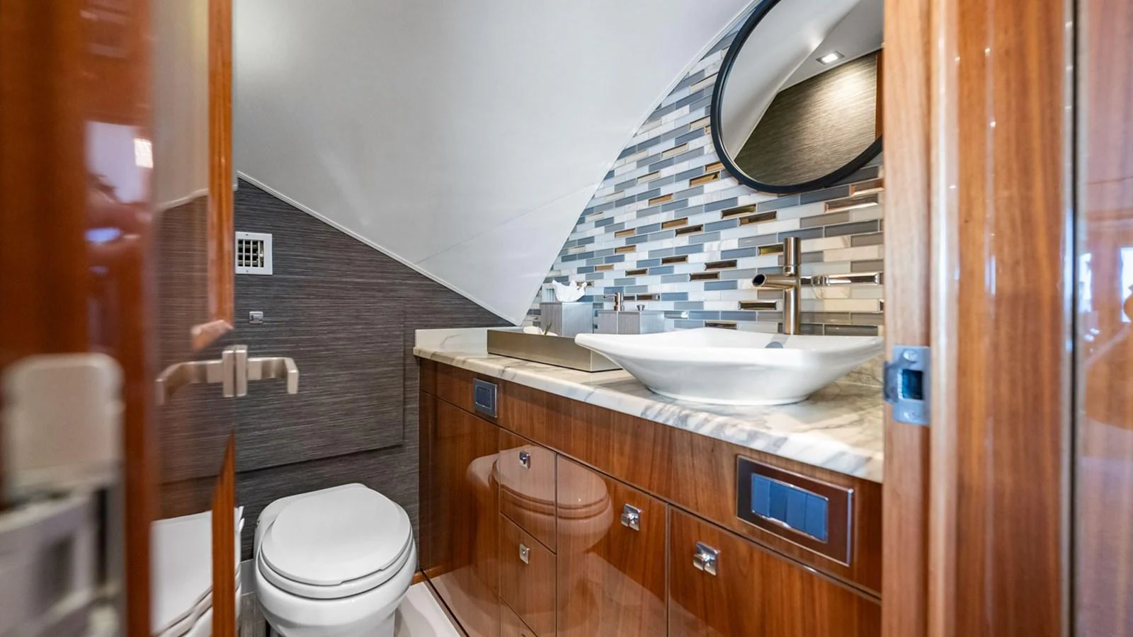 A luxurious yacht bathroom featuring modern fixtures and elegant wood finishes. aboard DOUBLE BARREL Yacht for Sale