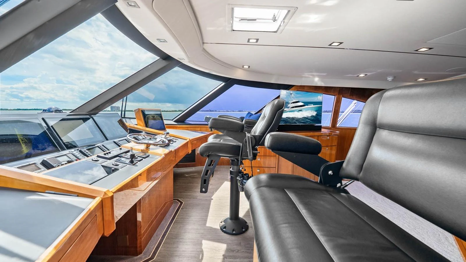 The helm station features state-of-the-art navigation equipment and luxurious seating with panoramic views. aboard DOUBLE BARREL Yacht for Sale