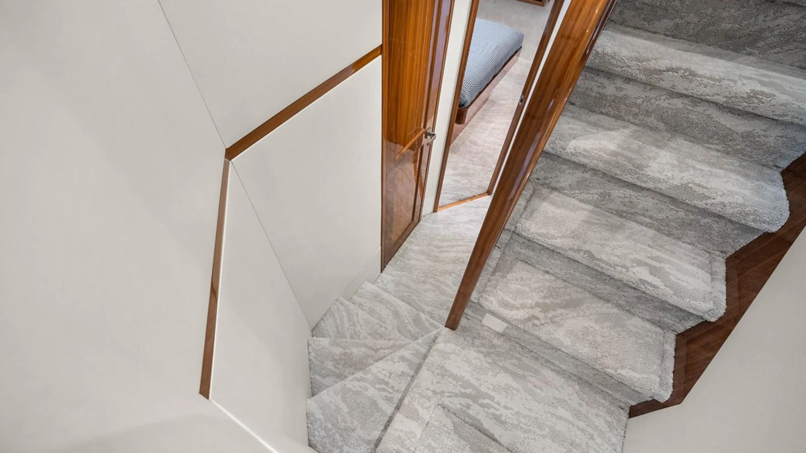 A luxurious staircase with plush carpeting leads to the lower deck. aboard DOUBLE BARREL Yacht for Sale