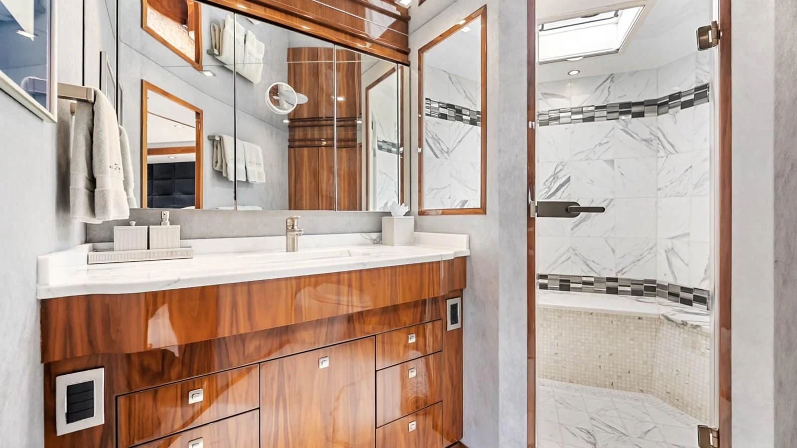 The yacht's bathroom features a luxurious design with marble accents and high-quality wood finishes. aboard DOUBLE BARREL Yacht for Sale
