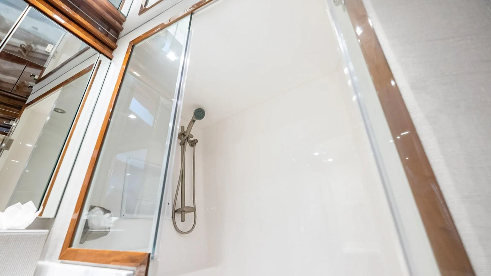 The yacht's bathroom features a sleek, modern shower area with elegant fixtures. aboard DOUBLE BARREL Yacht for Sale